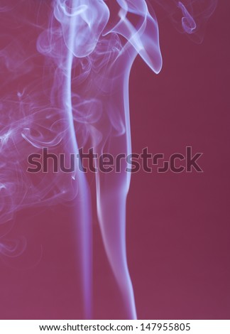 An abstract photo close up - solid purple background with a smokes swirls