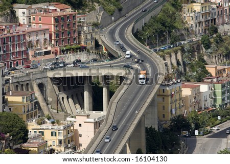 Bird\'s eye view of multi-level flyover in mountain city somewhere in Italy