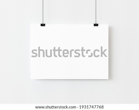 One blank horizontal rectangle poster template hanging on thread with paper clips on white background. 3D illustration