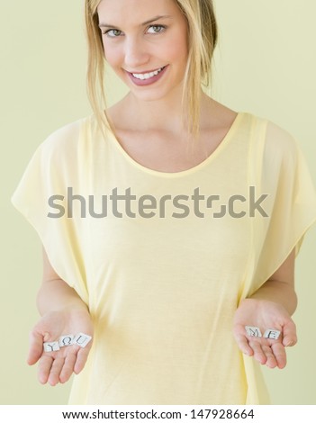 Portrait of beautiful young woman holding letter blocks reading \