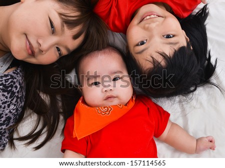 mother, sister and baby on the floor laying on