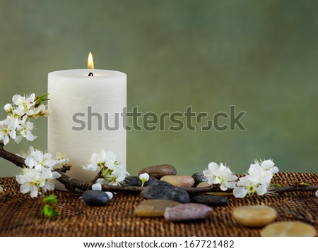 Zen rock and Cherry blossom with white candle on mat