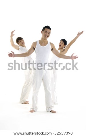 Group of three people in white cloths in a gym doing gymnastics