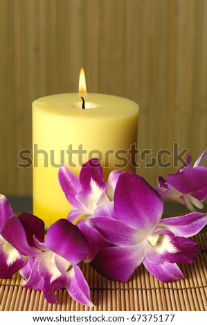 rose and candle with on bamboo stick straw mat background
