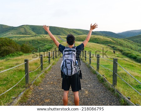 handsome Healthy man raises his arms up on mountain  handsome Healthy man raises his arms up on mountain