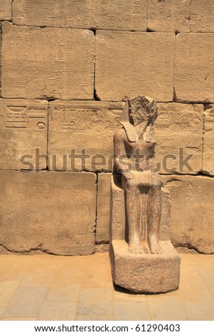 Pharaoh statue without face and wall with hieroglyphics in Karnak temple, Luxor, Egypt (HDR photo)