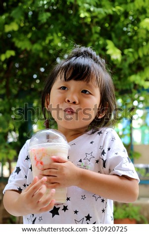 children drinking smoothie milk from plastic bottle with happy face