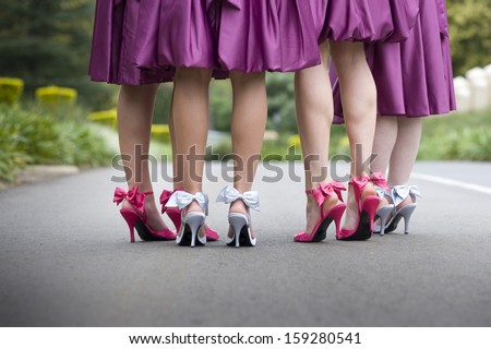 a group of women wearing bow high heels and purple skirts