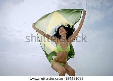 young beautiful girl having fun with Brazil flag