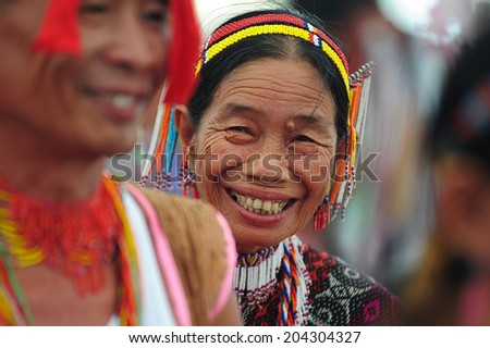Kota Kinabalu, Sabah, Malaysia - May 30 2014: A lady from the Dusun Rumanau Leboh ethnic showing her colorful traditional costume during the Sabah State Harvest Festival celebration at Sabah Borneo.
