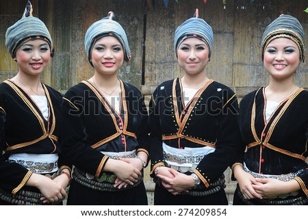 Tambunan, Sabah Malaysia. May 1, 2015 : Ladies from Dusun Tambunan ethnic wearing traditional costume poses for the camera during the Harvest Festival celeberation in Tambunan, Sabah.