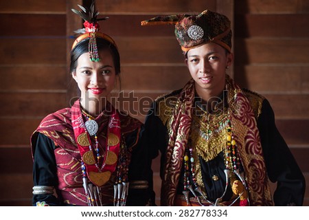 Penampang, Sabah Malaysia.May 31, 2015 : Dusun Lotud couple in traditional costume with high contrast shadow windows lighting during Pesta Kaamatan in Sabah Borneo.