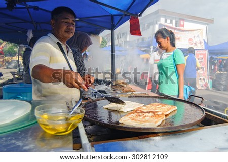 Tuaran Sabah Malaysia-July 11, 2013:Unidentified food vendor selling famous Malaysian food called martabak at open bazar. Open bazar is popular among Malaysian to buy food especially during weekend.