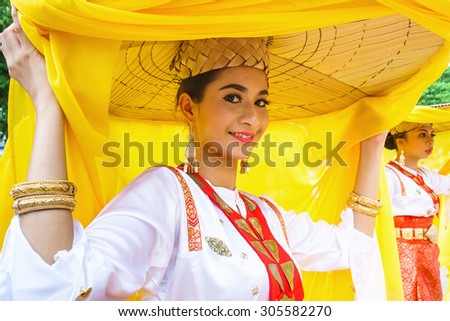 Kota Kinabalu Sabah Malaysia-August 12, 2015:Performer in traditional costume from Sarawak Malaysia greeting the public audience during Sabah International Folklore Festival at Kota Kinabalu.