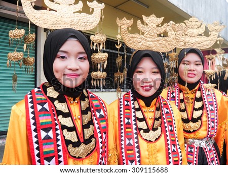 Kota Belud Sabah Malaysia-August 23, 2015:Bajau ladies in traditional costume pose for the camera during festival.Bajau tribe, among the bigest tribe in Sabah is famous with striking costume colors.