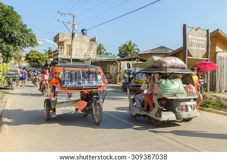 El Nido Palawan Philippines - March 22, 2014:Tricycle bike taxi moving along street heading to El Nido town on March 22, 2014. Tricycle are the most popular public transportation in the Philippines.
