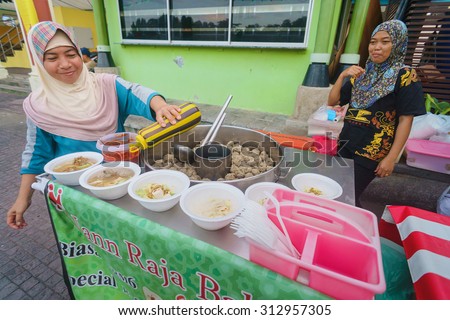 Kuching Sarawak Malaysia-September 3, 2015:Unidentified muslim street food vendor preparing local dish called Bakso at Kuching Waterfront esplanade on September 3, 2015.