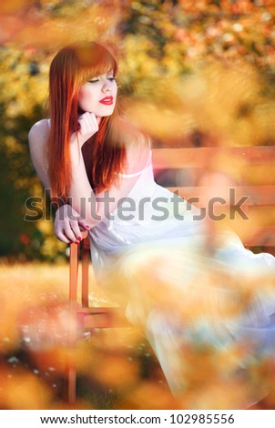 Beautiful girl relaxing in a magic garden
