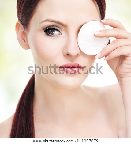 Make up removal concept, beautiful young adult woman with cotton pad
