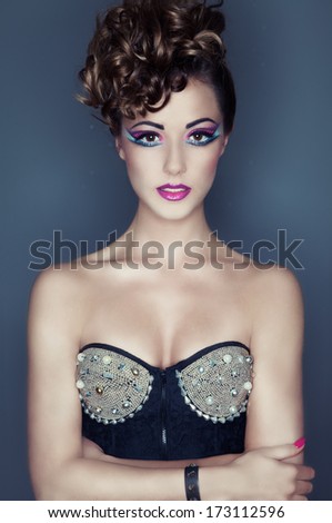 Beautiful young woman with professional party make up and corset