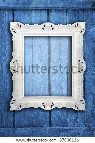 Ornamental white frame on an aged  wooden background, similar available in my portfolio