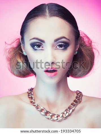 Face close up of beautiful young woman with professional party make up gold chain necklace