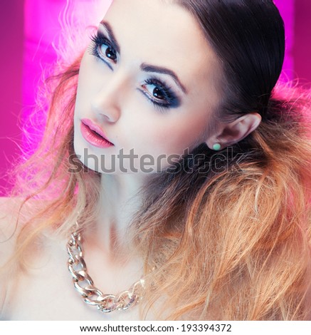 Face close up of beautiful young woman with professional party make up false eyelashes