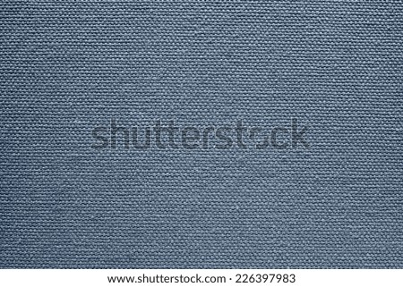 abstract texture of rough cotton fabric or canvas with drawing from fibers a cross crosswise for backgrounds of silvery blue color