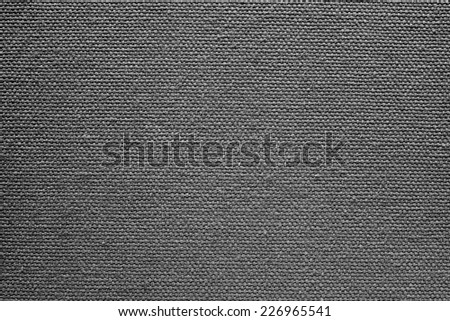 abstract texture of rough cotton fabric or canvas with drawing from fibers a cross crosswise for backgrounds of black color