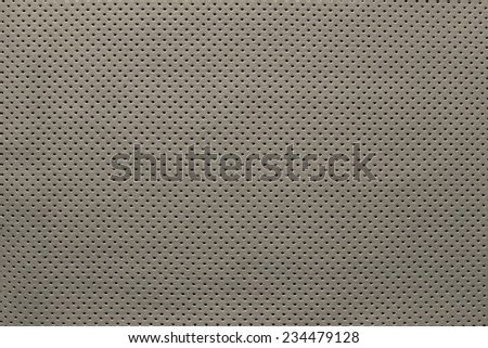 outer side of texture of leather fabric of beige color for pure backgrounds with the punched openings