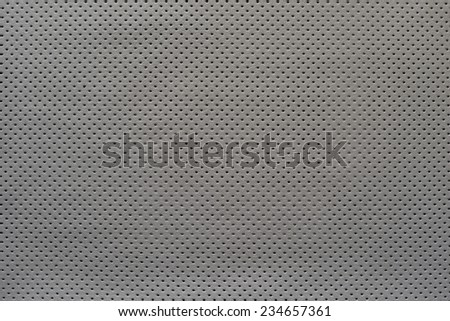 outer side of texture of leather fabric of silvery gray color for pure backgrounds with the punched openings