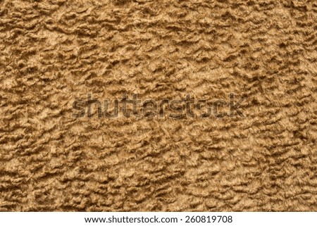 abstract texture of sand color of short-haired fur fabric with wavy curls for empty backgrounds