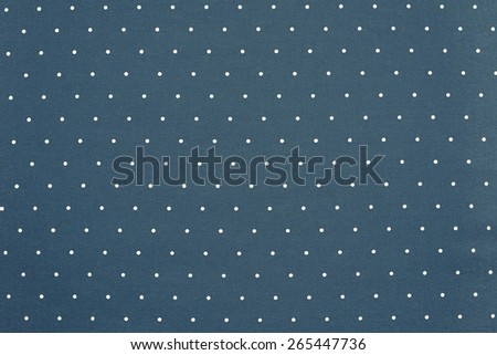 the abstract textured background of blue color fabric and round light specks are located in ranks on a surface on all area