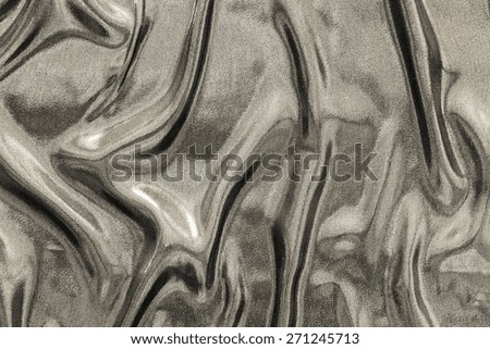 abstract background fabric with the crumpled wavy texture of beige glossy color for empty and pure backgrounds