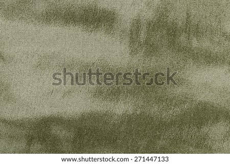 abstract grained texture of spotty fabric of dark green color for empty and pure backgrounds