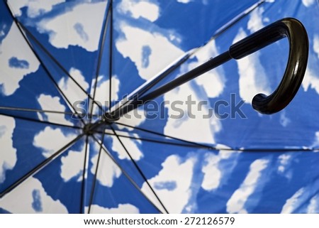abstract fragment of an umbrella cane from within closeup with a spotty surface of blue white color