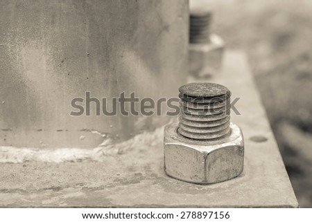 industrial composition from nut and bolt on a construction support closeup