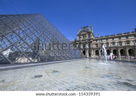 PARIS - AUGUST 11: Louvre pyramid during the Summer Exhibition on August 11,2013 in Paris.Louvre is the biggest Museum in Paris displayed over 60,000 square meters of exhibition space.