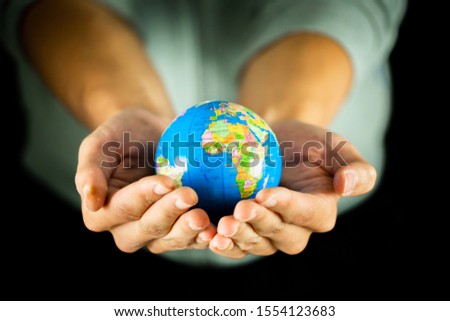 Similar – Image, Stock Photo Male hand holding globe in a plastic bag. Contaminated Earth