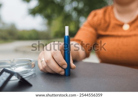 Similar – Image, Stock Photo Modern relaxed woman vaping while sitting on marked road