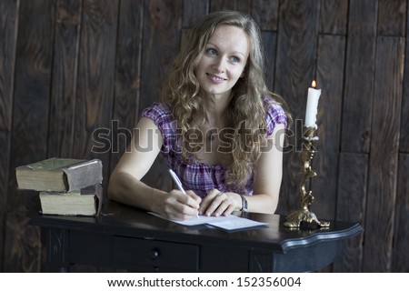 Young woman write a letter