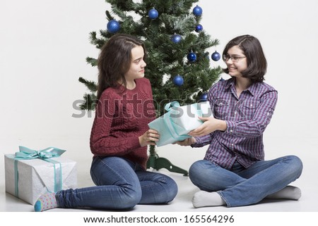 Friends sharing Christmas gifts