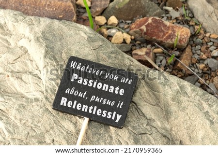 Motivational quote on chalkboard on stone beach background - Whatever you are passionate about, pursue it relentlessly. 商業照片 © 
