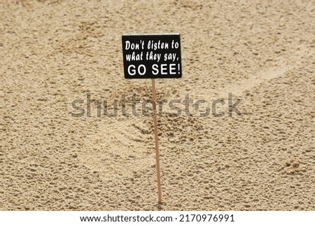 Motivational quote on chalkboard on sandy beach background - Don't listen to what they say, go see. 商業照片 © 