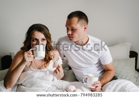 https://image.shutterstock.com/display_pic_with_logo/174707686/794983285/stock-photo-a-man-and-a-woman-drink-coffee-and-eat-marshmallows-in-bed-in-bedroom-the-valentine-s-day-concept-794983285.jpg