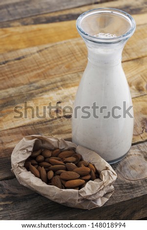 Almond milk. Healthy blended almond on wooden table. Studio shot at daylight, shallow depth of field.