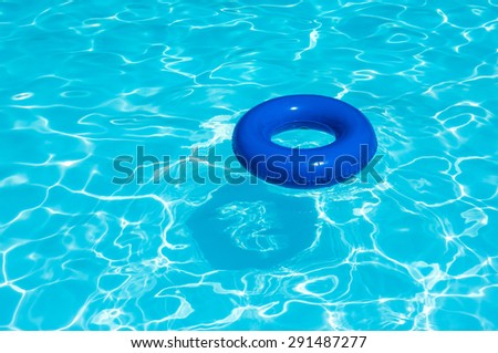 Blue buoy on water pool