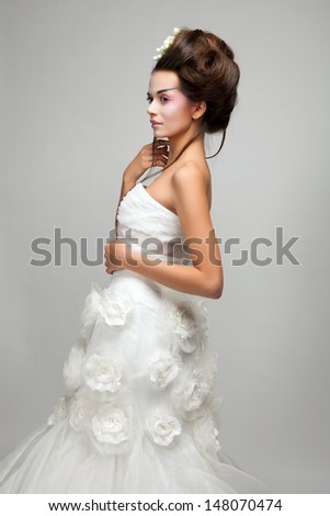 young beautiful bride sitting on a bench studio shooting
