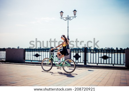 stylish girl hipster riding a  cruiser bicycle