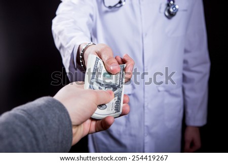 close-up doctor takes money